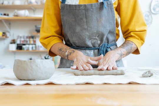 Anonymous woman making earthenware from clay