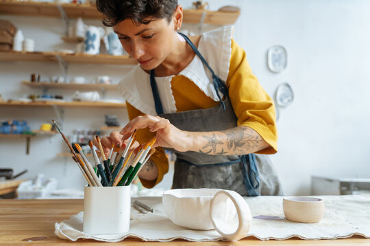 Young woman ceramist at her studio