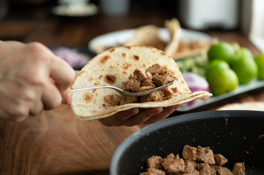 Preparing Mexican tacos pork carnitas