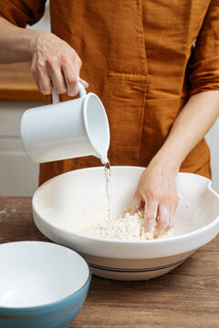 Crop woman chef making Indian flatbread at home