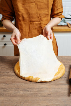 Crop woman chef making Indian flatbread at home