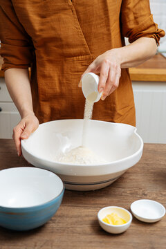 Crop woman chef making Indian flatbread at home