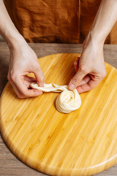 Crop woman chef making Indian flatbread at home