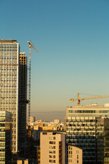 Fototapeta na wymiar morning skyscrapers and construction crane