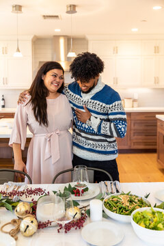 Man and Woman Smile in front of Dining Table Together