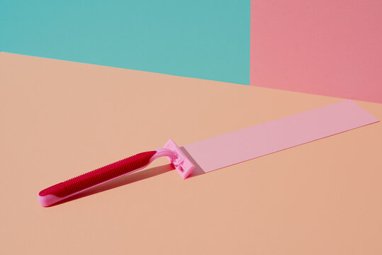 pink razor on a salmon pink background
