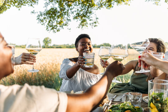 Women Friends Enjoying Drinks At Outdoor Party