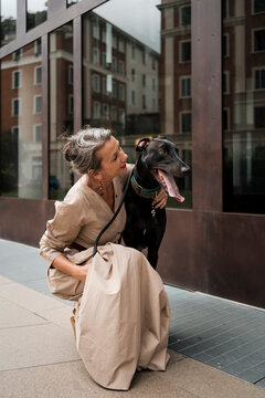 Adult Trendy Woman with her dog in the city