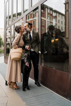 Adult couple having fun outdoor with the dog