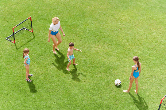 Mom and kids playing soccer