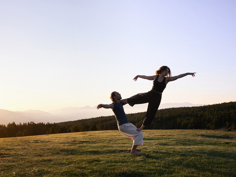 Couple doing acro yoga