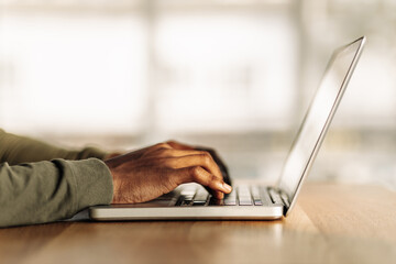close-up of hands are typing on a laptop. side view. job search via the Internet. online work. online shopping