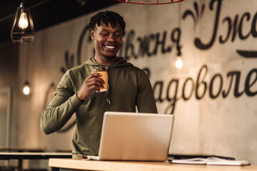 American African man with laptop at the table. distance learning. office worker with laptop. online call.