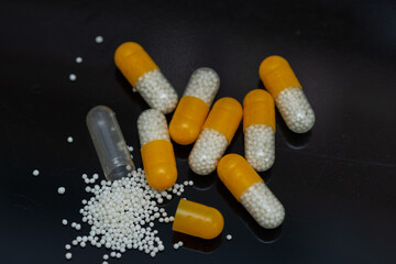 white yellow pills with white granules inside