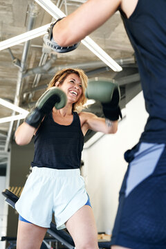 sportswoman exercising with coach during workout