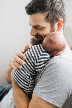 father burping baby