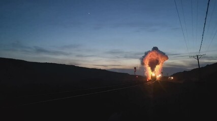 A steam train on the Sandoling coal mine in the city of Hami in the northwest of Xinjiang Uygur Autonomous Region of China. Steam engine throws sparks from the chimney at night.