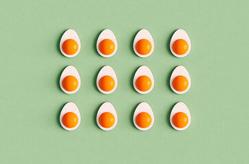 3D render of boiled eggs cut in half organized on green