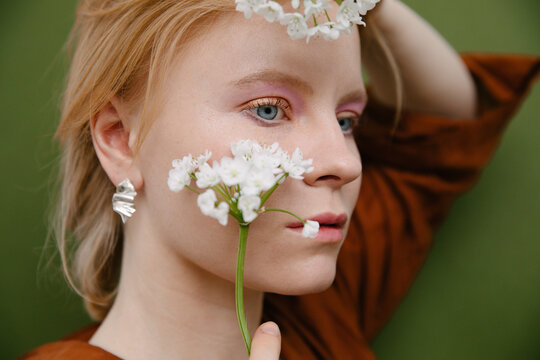 portrait of a redhead model with make up and flowers