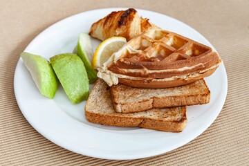Western breakfast set plate, croissant, toast and fresh fruit