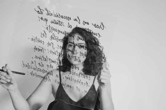 Female Artist Doing Calligraphy on Glass