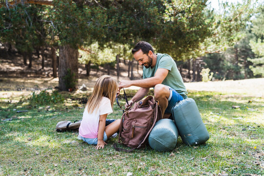 Father and daughter unpacking bags