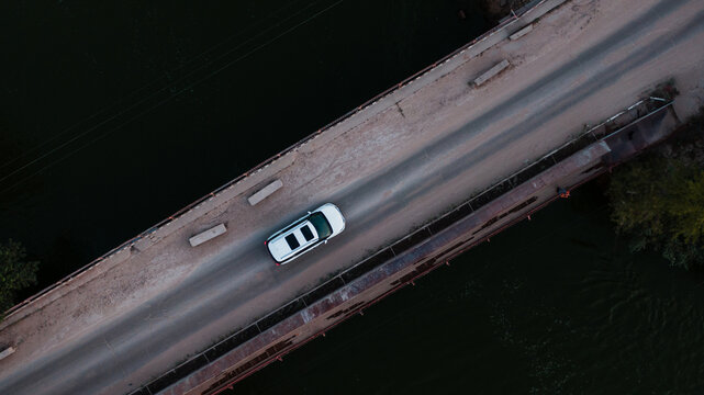 aerial view of a brand new car crossing the bridge