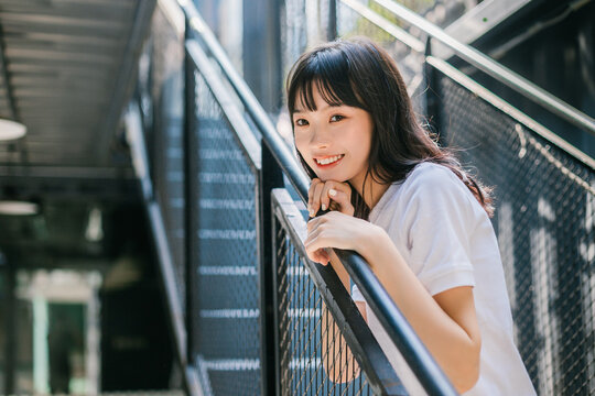 Woman leaning on the stair railing