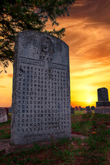 The Bean cryptic gravestone in Rushes Cemetery in Ontario, is seen during a late evening sunset.