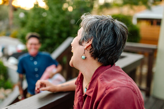 Laughing wife of same-sex couple on deck