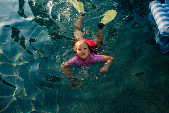 Girl With Fins Swimming In Pool