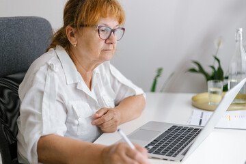Senior woman writing in a notebook