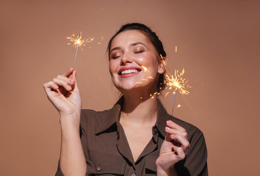 Cheerful woman with sparklers 