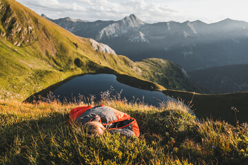 boy in sleeping bag high up in the mountains