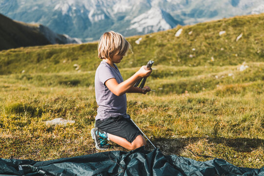 Boy Pitching A Tent