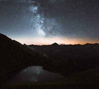 milky way above mountain lake