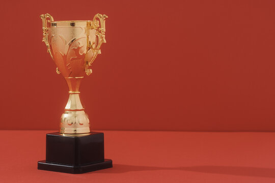 Winning Concept With Trophy On Two Tone Background