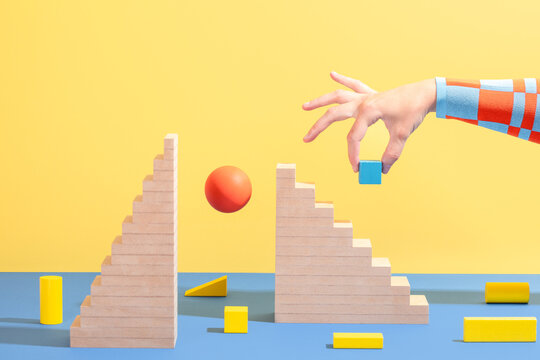 Hand with wooden stairs