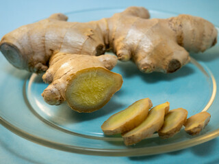 Cut ginger root on a transparent plate.