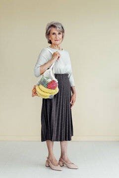 Senior woman with food in eco bag