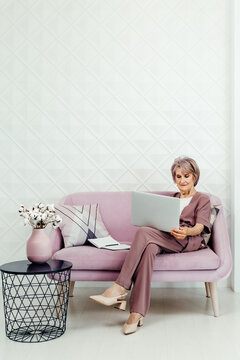 Senior businesswoman using laptop at home
