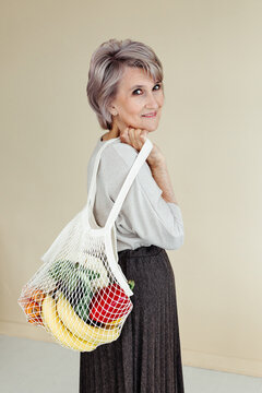 Senior woman with groceries in eco bag