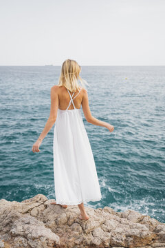 Beautiful Blonde Woman Walking By The Sea