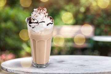 Latte coffee in a beautiful cup, foamy coffee and milk drink in a transparent glass cup.