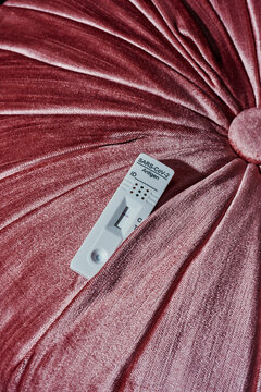 negative covid-19 test on a pink cushion