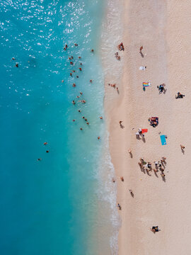 people swimming in water on the beach, summer vacation