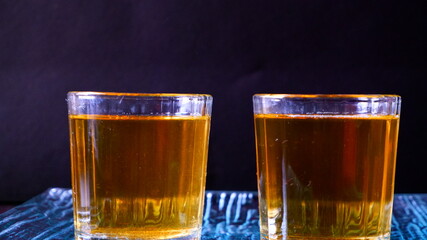 Glass of Dark Green tea with black background 