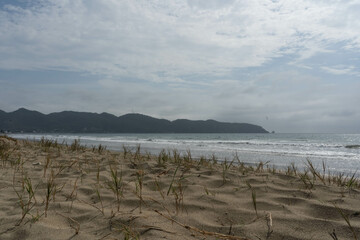 clouds over the sea with a mountain in the background
