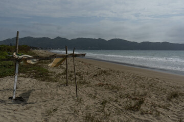 Landscape of a beach with a small stand in the foreground and a mountain in the background