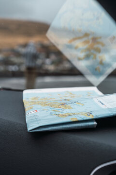 Folded map on car dashboard 